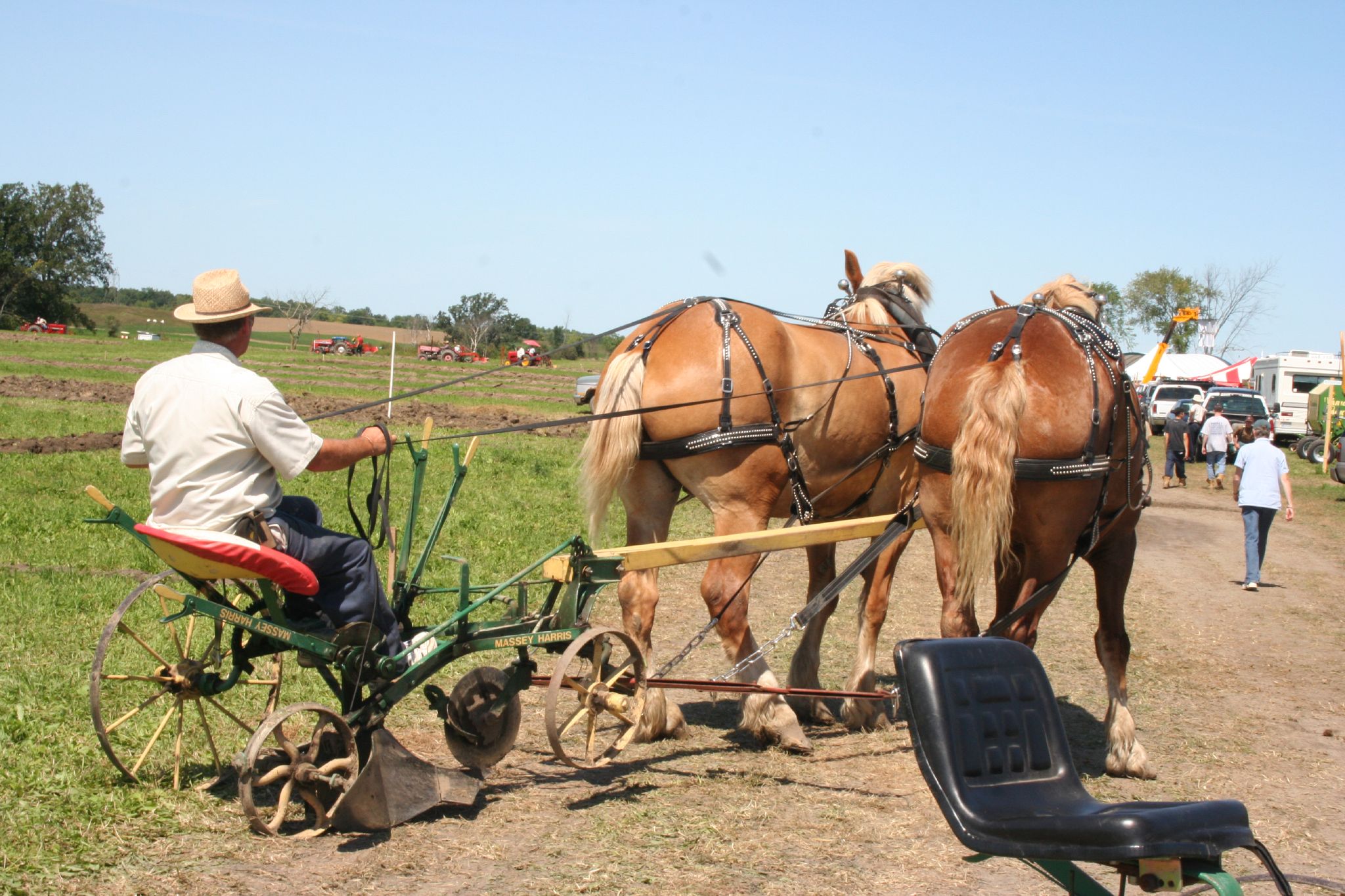 a farmer is sitting on the back of his horse drawn cart