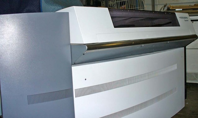a large white computer equipment with several parts underneath
