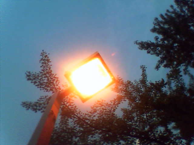 a street light lite up by the fog