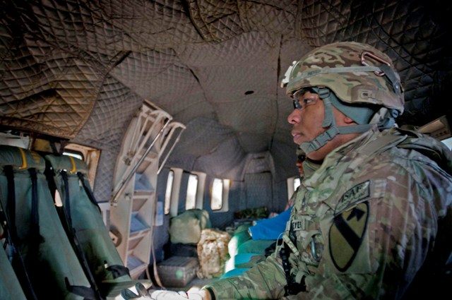 two men in military uniform inside a vehicle