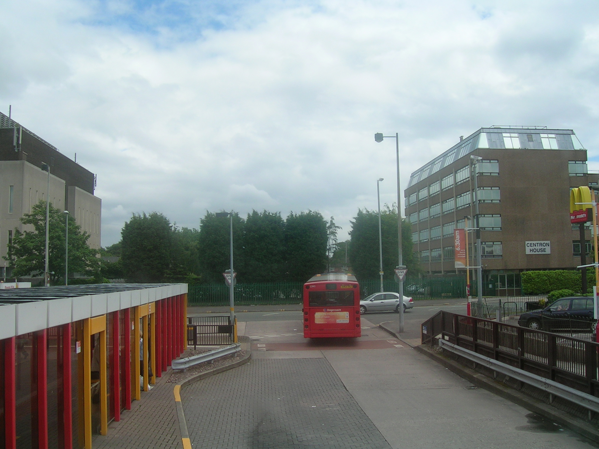 a red double decker bus traveling down a street