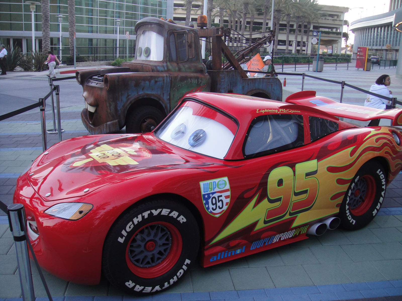 a red race car with cars painted on the side