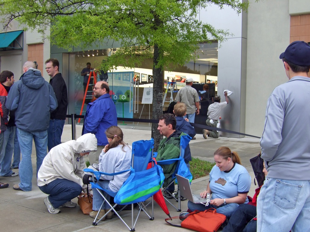 a group of people gather on the side walk for an event