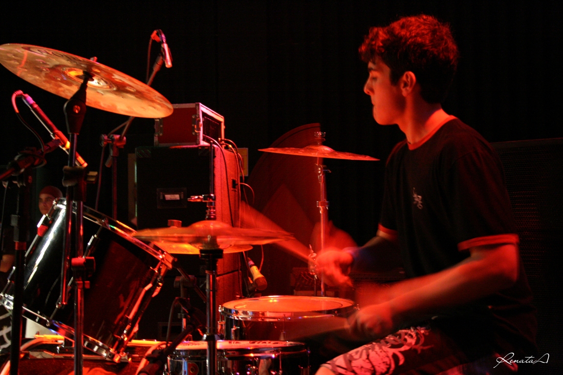 a young man is playing drums on the stage