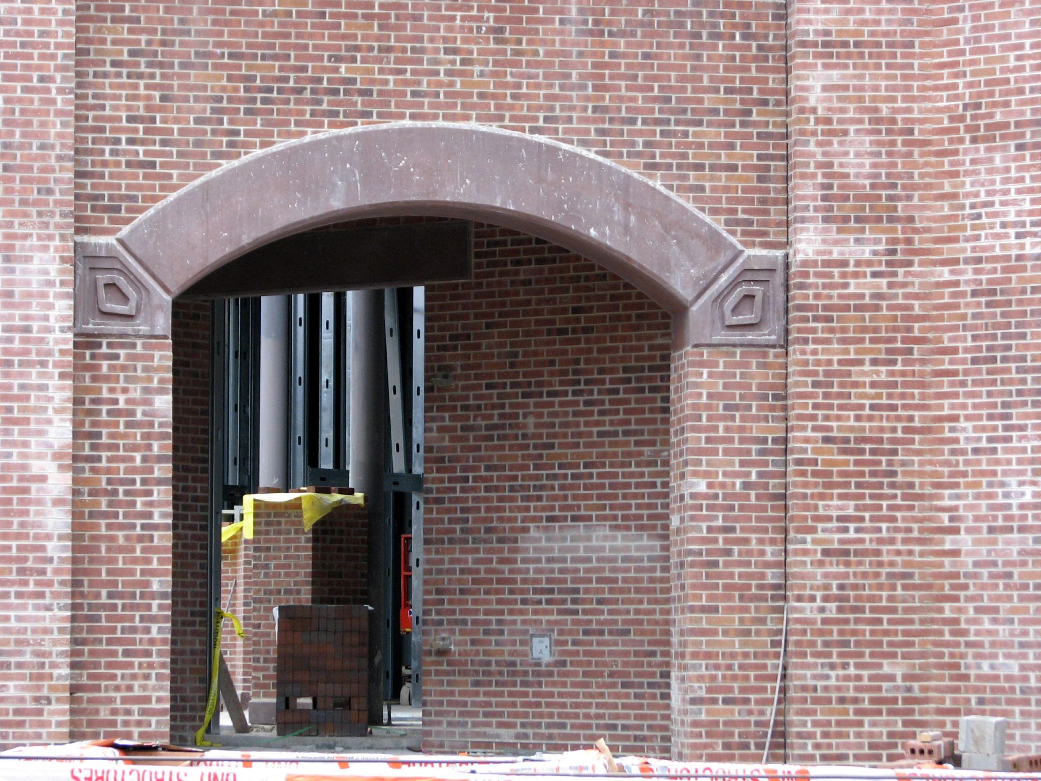 a large archway to a brick building under construction