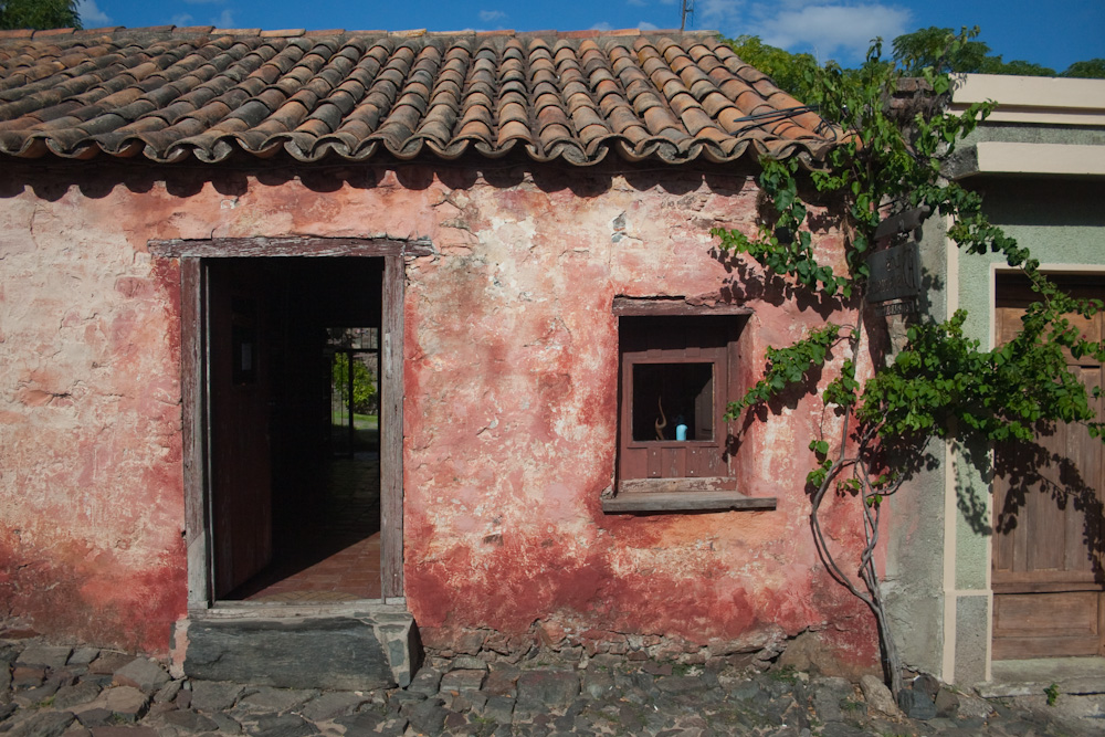 a red brick building has two open windows on each side