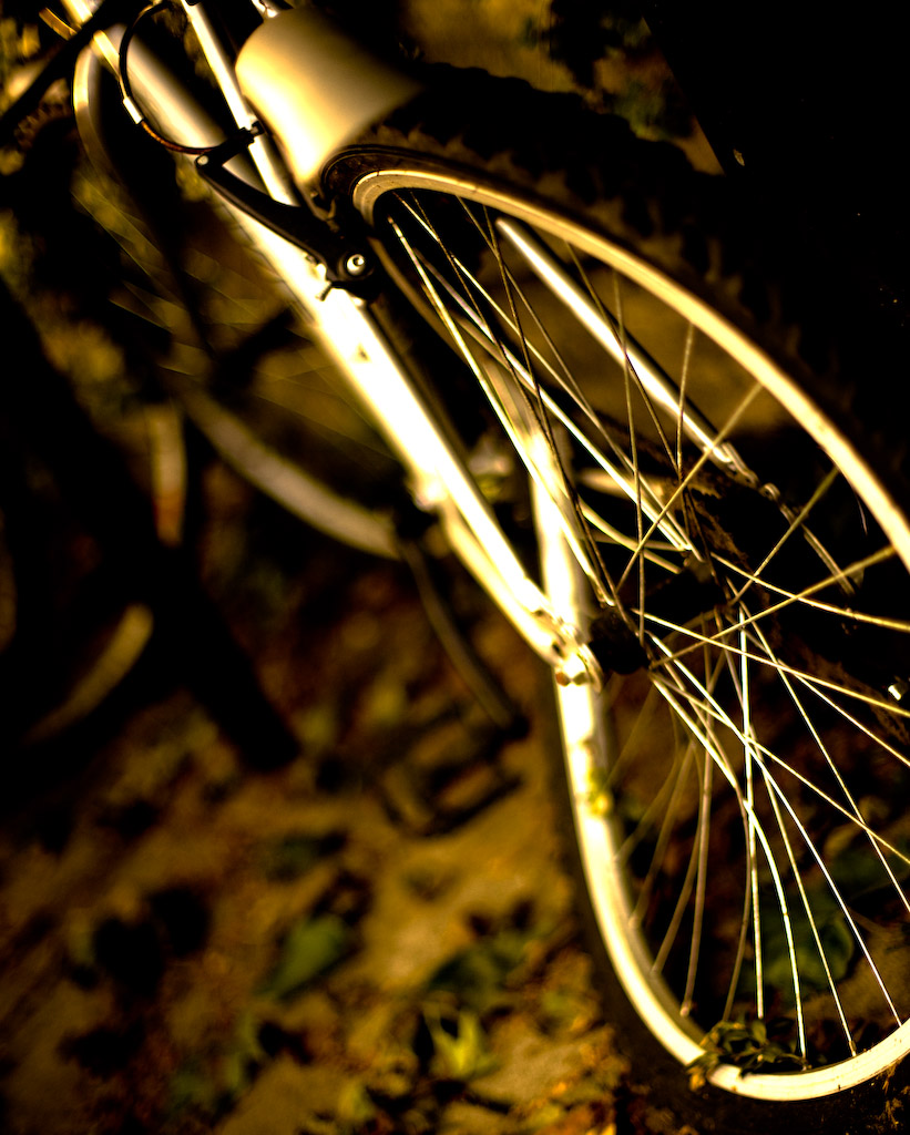 a bike is shown at night with the headlights on