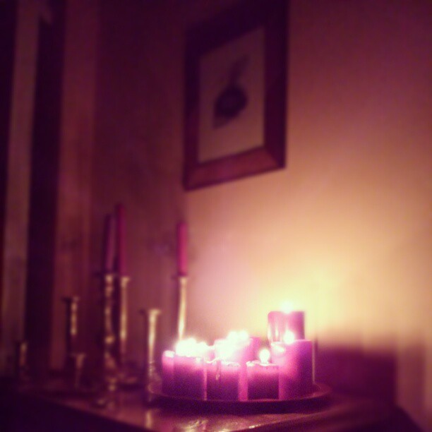 purple lit candles on a table in a room