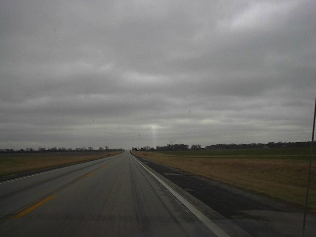 a grey cloudy sky looms above an empty runway