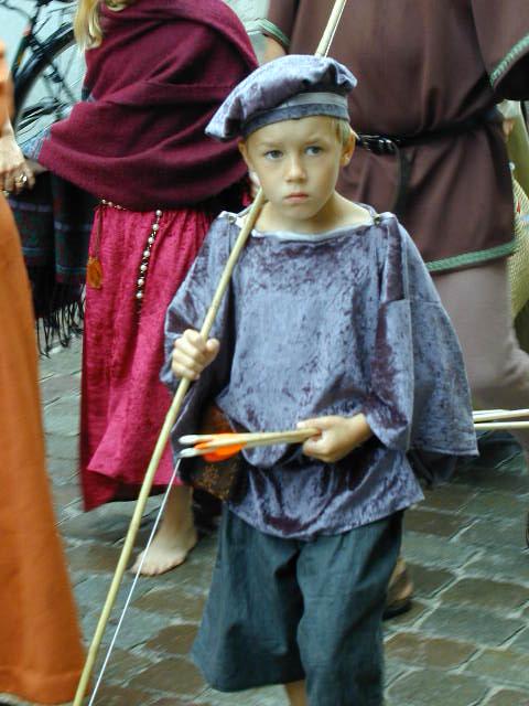 a little boy dressed up in a knight's costume