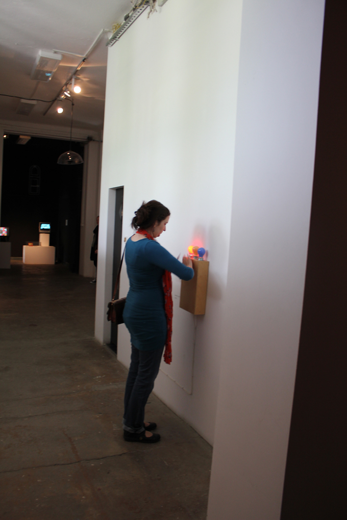 a woman is looking at the wall sconce that matches