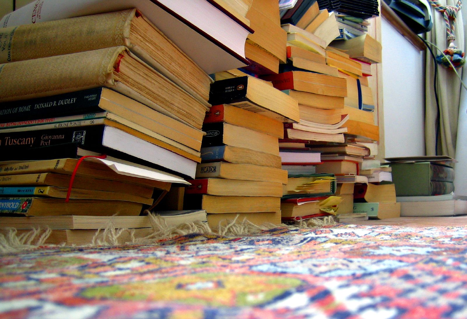 a room full of books stacked on top of each other