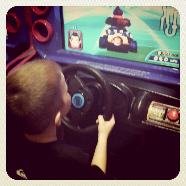 a little boy in front of a television while playing video games