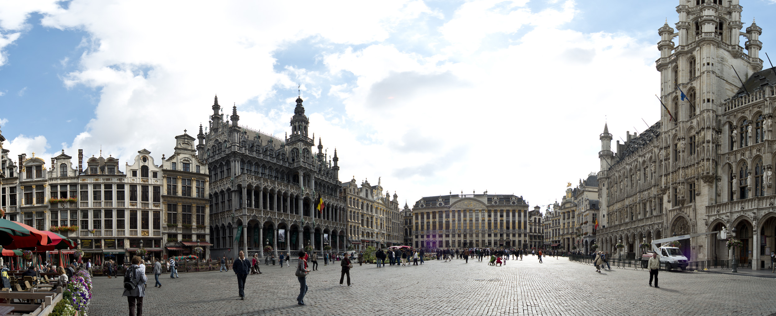 a city with lots of buildings and towers and people walking down the street