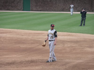a baseball player standing in the dirt on a field