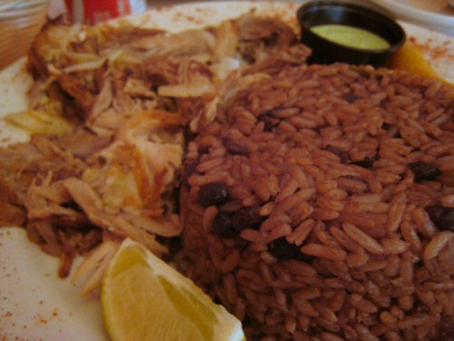 a plate full of mexican rice with salsa