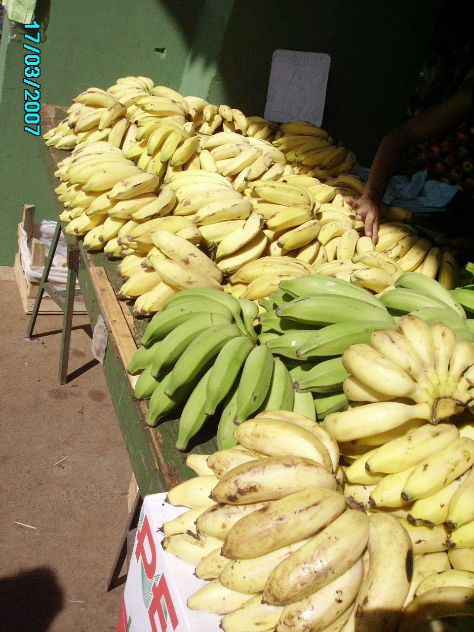 piles of bananas on the table outside