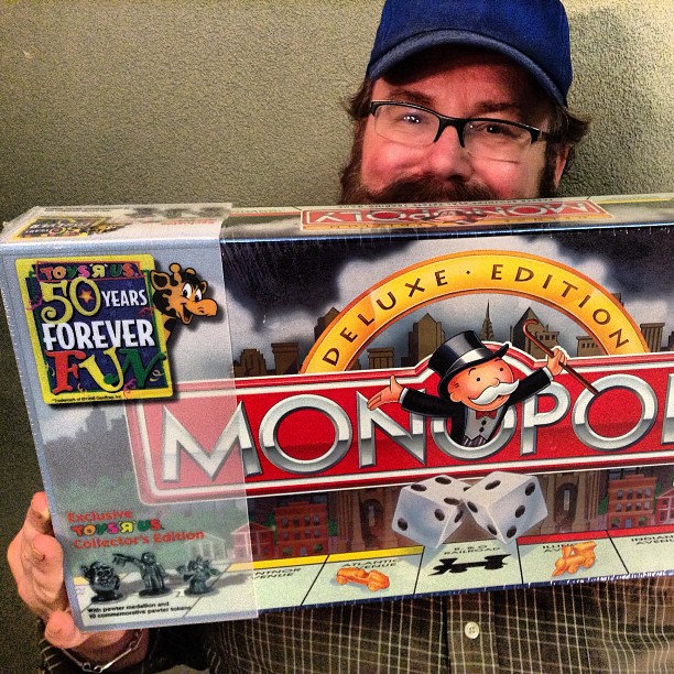 a man holding a monopoly board game in his hands