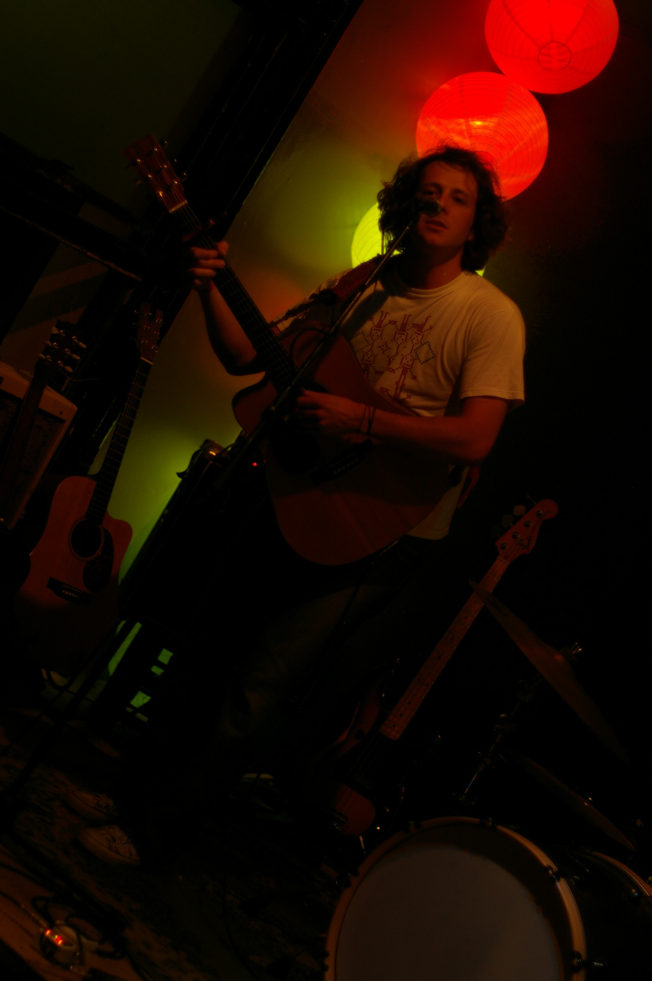 a person with a guitar playing at the same time