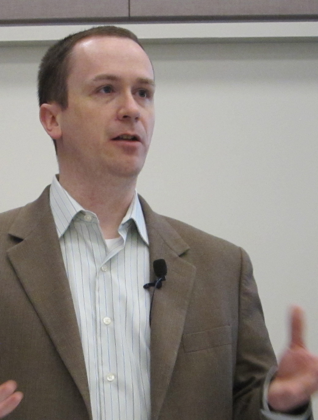 a man standing in front of a podium giving a lecture