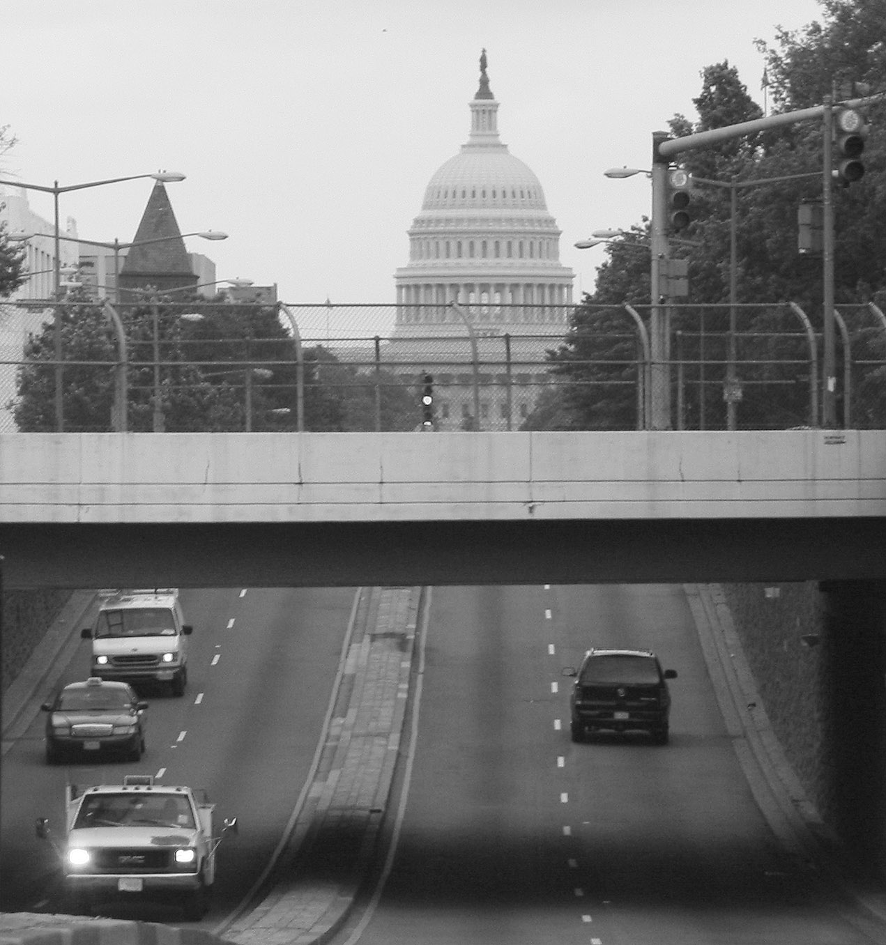 a few cars are driving down a city street