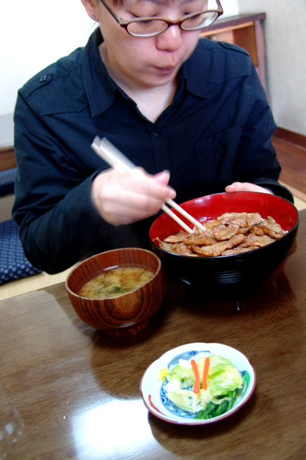 a man with chopsticks is about to eat chicken