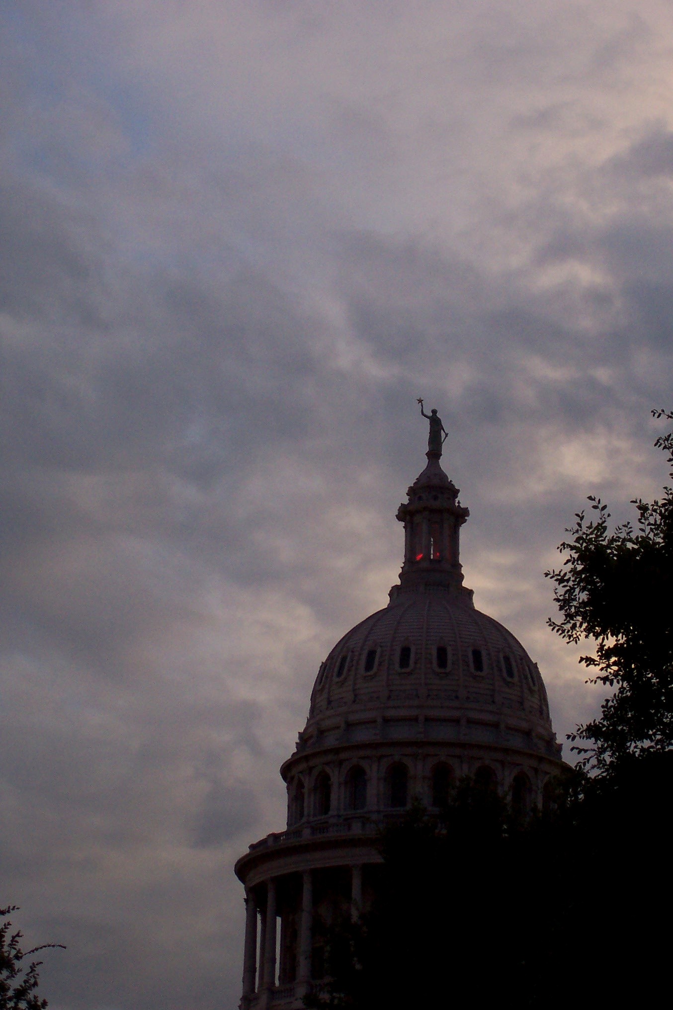 a church building with a clock tower against a cloudy sky