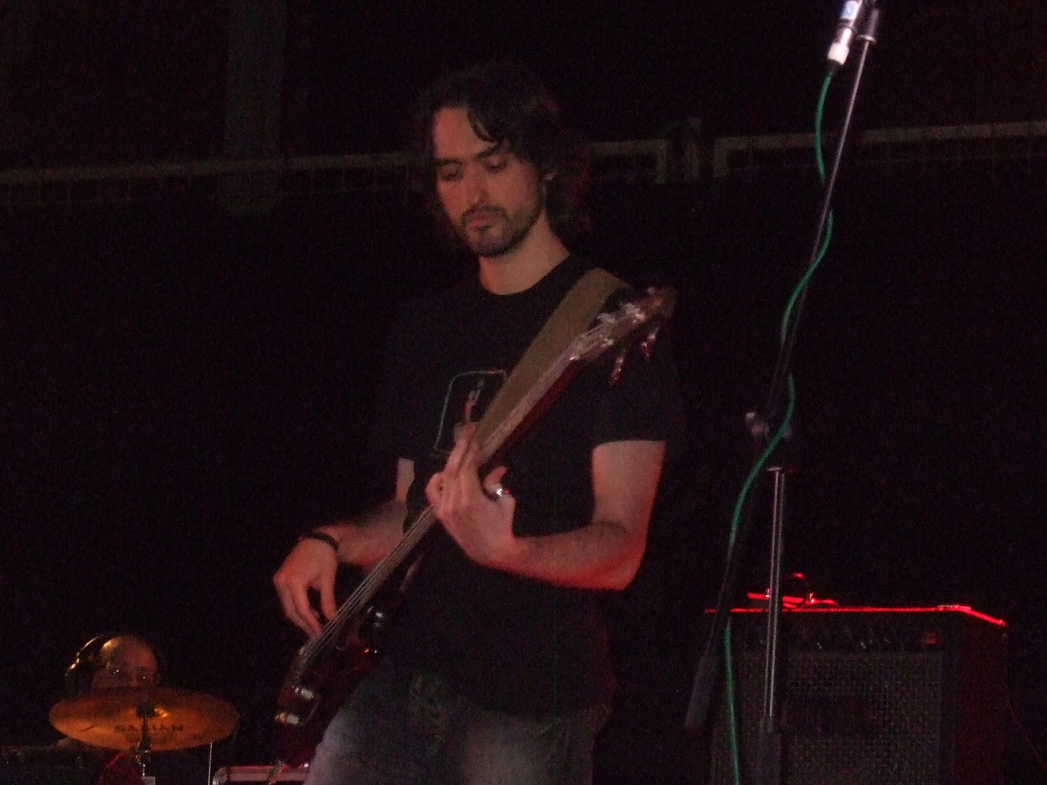 a man is playing guitar on stage at night