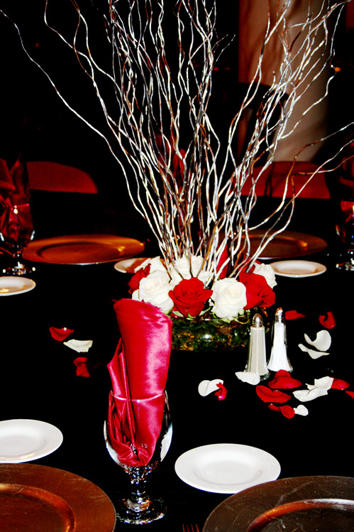 table set up with flowers in vase, plates and napkins