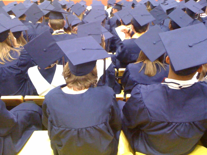 a group of students in graduation regals sitting together