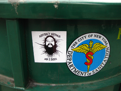 a green trash can has stickers with a man
