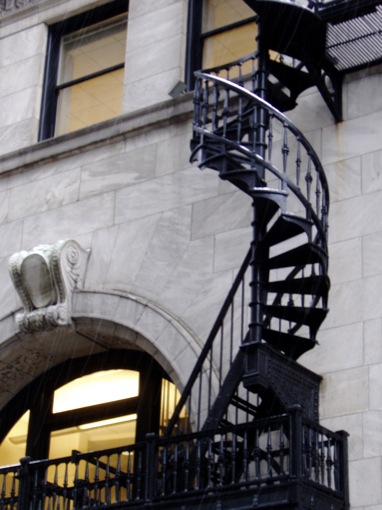 a fancy spiral staircase on the side of a building