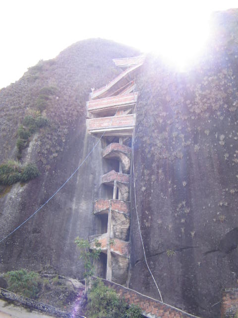 the view of a mountain with a steep cliff and sky