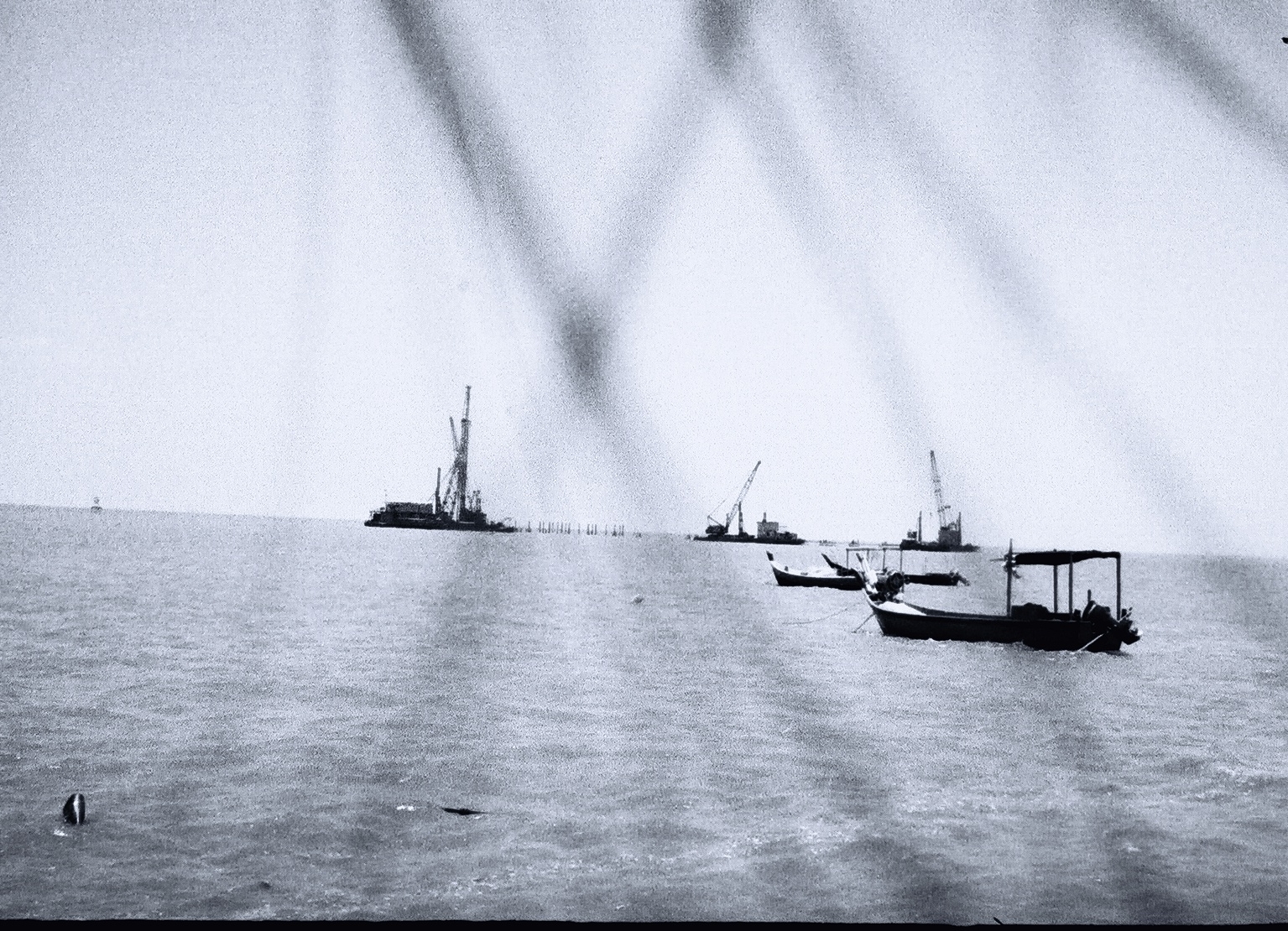 several boats floating across a large body of water