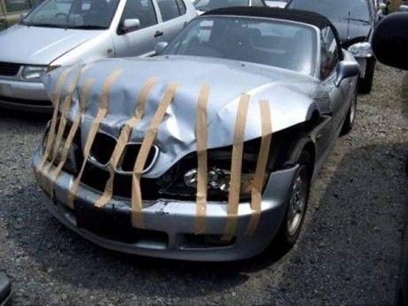 a car covered with golden tape on top of a road