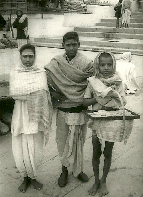 two people and a child in india, standing next to each other