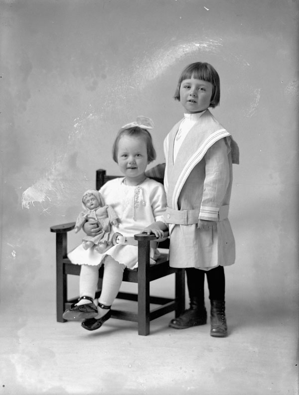 a  and a little girl sitting on a chair