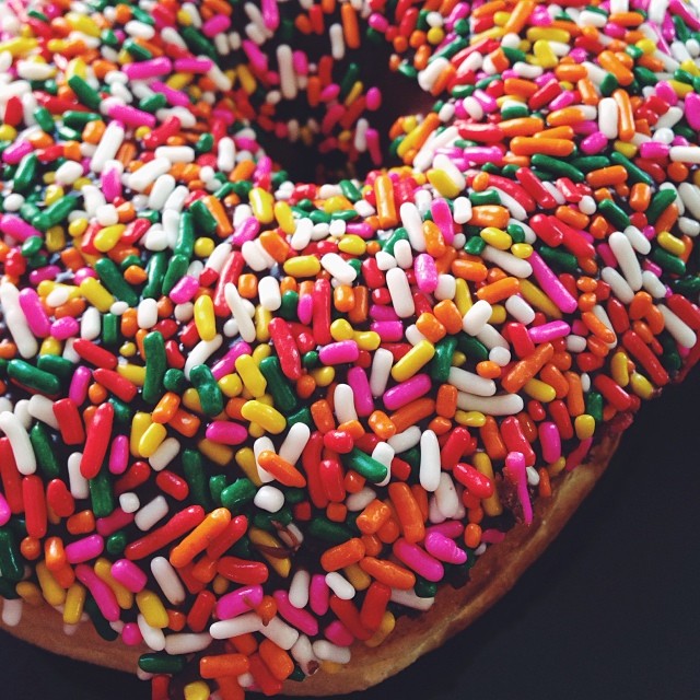 sprinkle covered doughnut on the table ready to eat