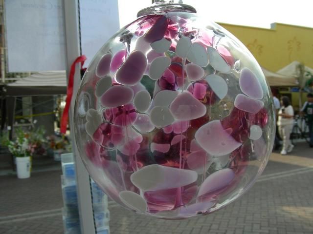 a round ornament filled with hearts attached to a pole