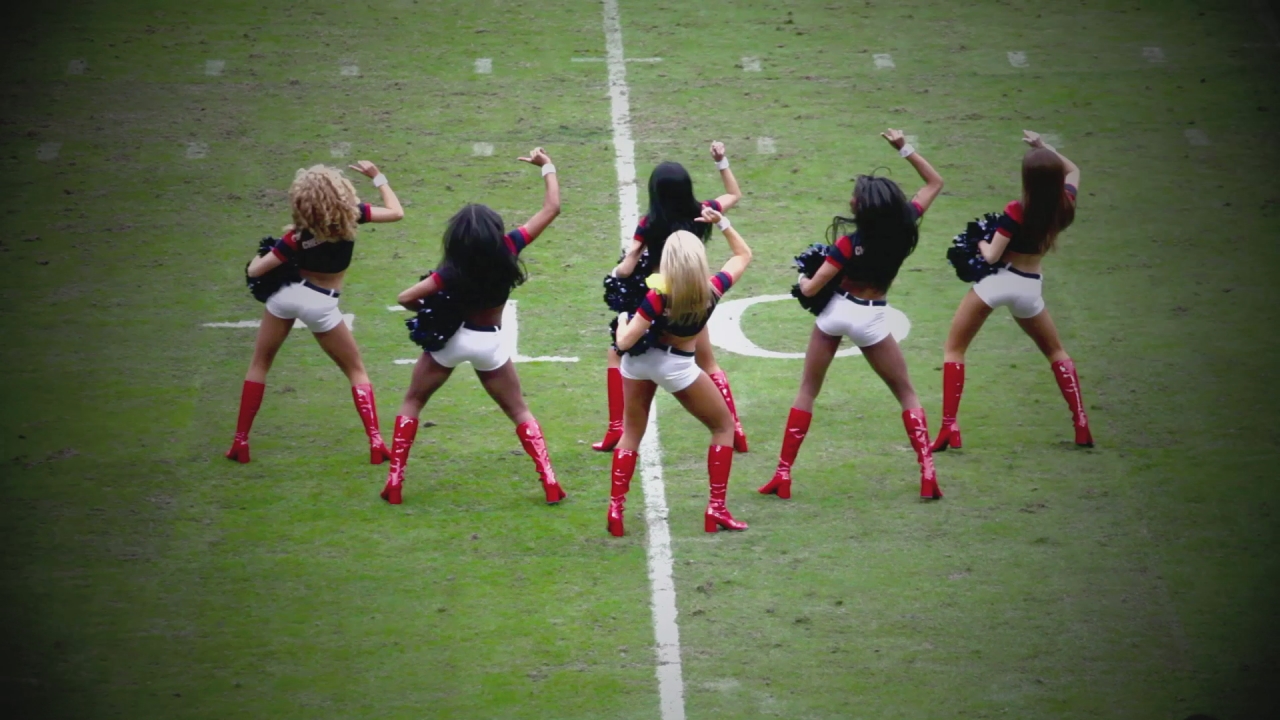a group of women on a field wearing red boots
