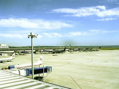 the airport and an airplane are parked on the tarmac