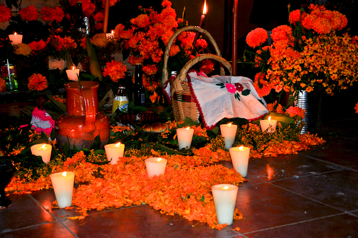 candles, flowers and some candles are sitting on the floor