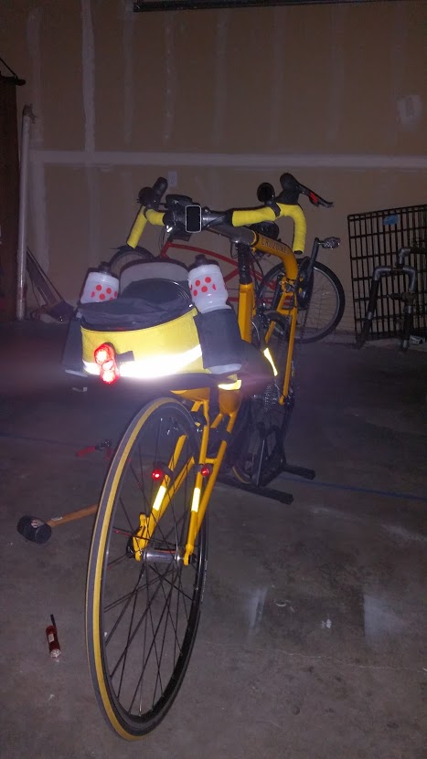 a yellow bicycle has many lights on it