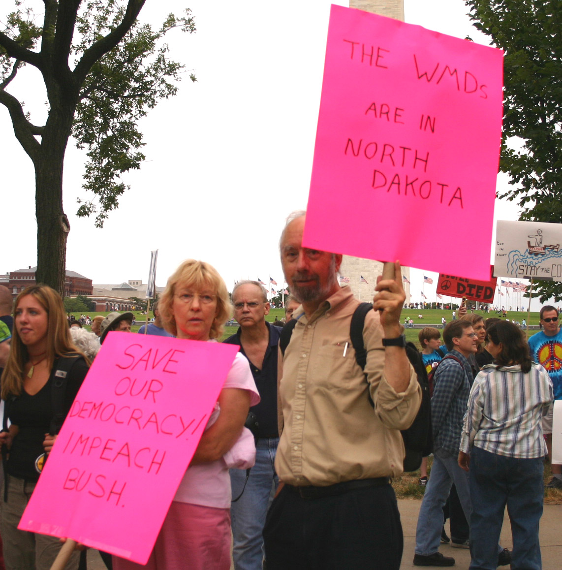 a man and woman are holding signs on the street