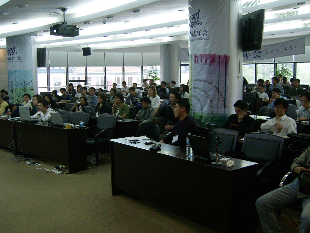 an assembly room filled with many students and laptop computers