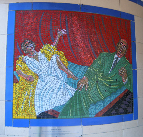 a mosaic portrait of a woman lying down on the ground with a man holding hands