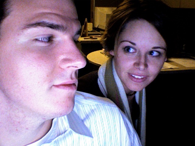 a man and woman looking at a computer screen