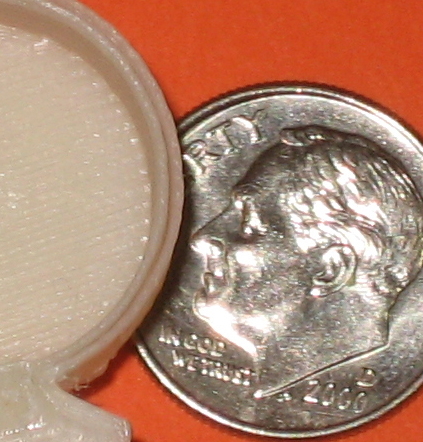 a dime with a white eraser sits on a bright orange surface