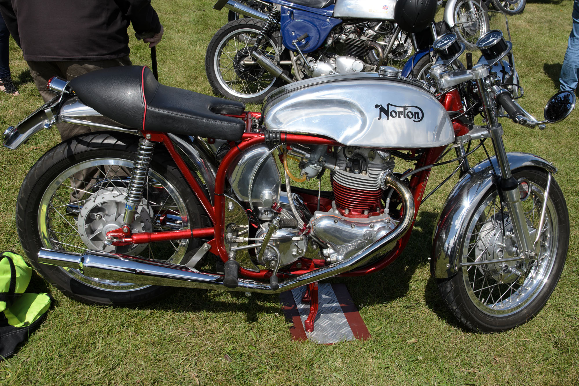 motorcycle on display with people standing behind it