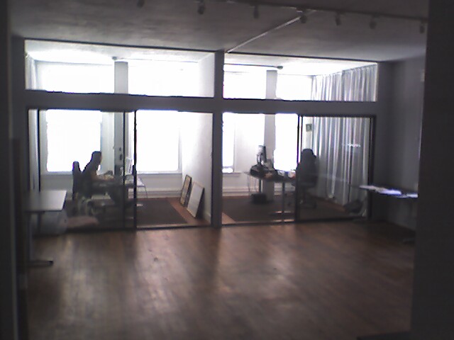 a office with a large glass door and desks